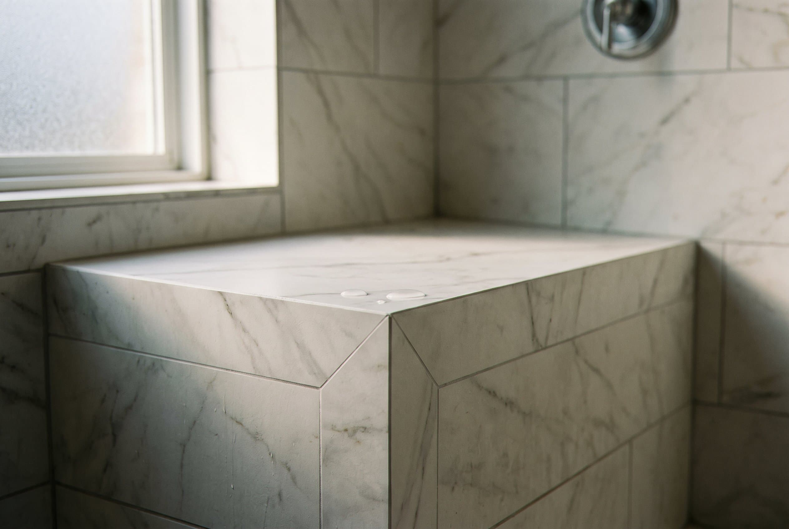 Curbless walk-in shower with large format wall tile